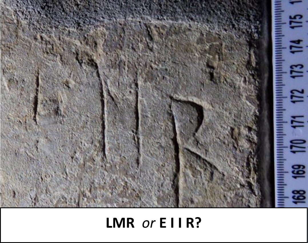 Photo of graffiti carved into stone. Text reads, "L M R or E I I R?".